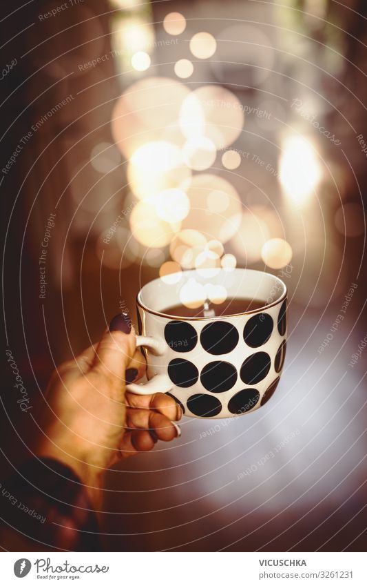 Hand holding cup with hot drink and BokeH Food Beverage Hot drink Hot Chocolate Coffee Tea Cup Lifestyle Design Living or residing Christmas & Advent Woman