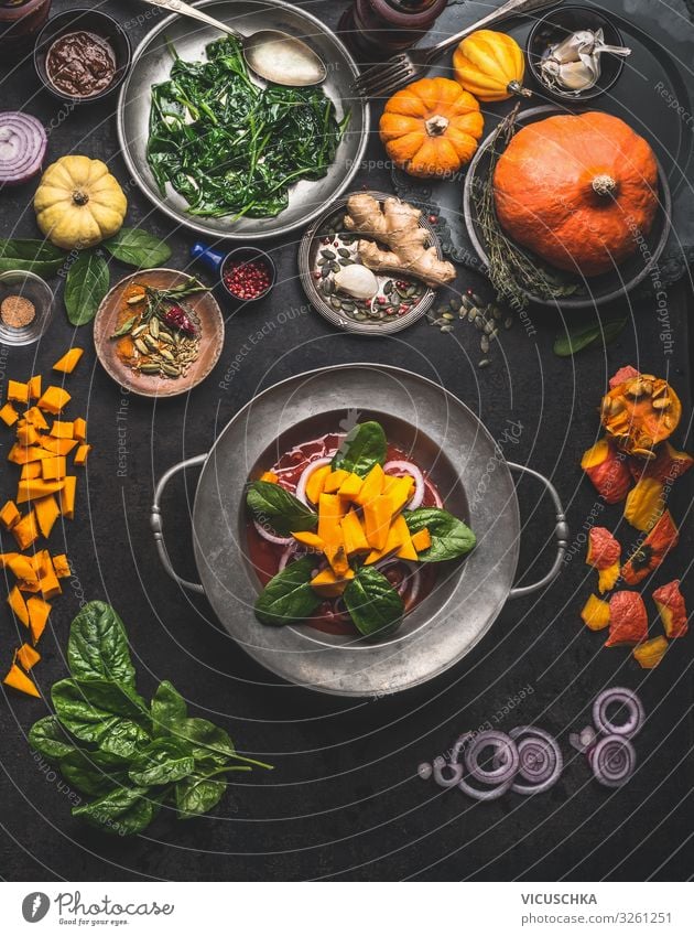 Cooking of seasonal vegetarian meals for autumn and winter Winter Thanksgiving Eating cooking pumpkin spinach ginger onion top view healthy food concept above