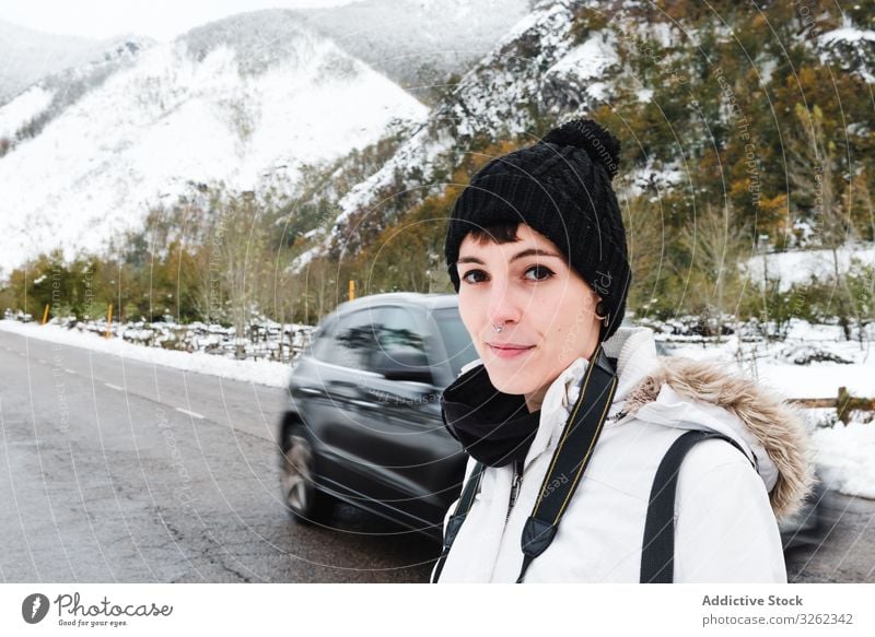 Woman visiting mountains in winter woman road walk vacation snow nature tourist adventure travel female landscape cold trekking activity explore environment