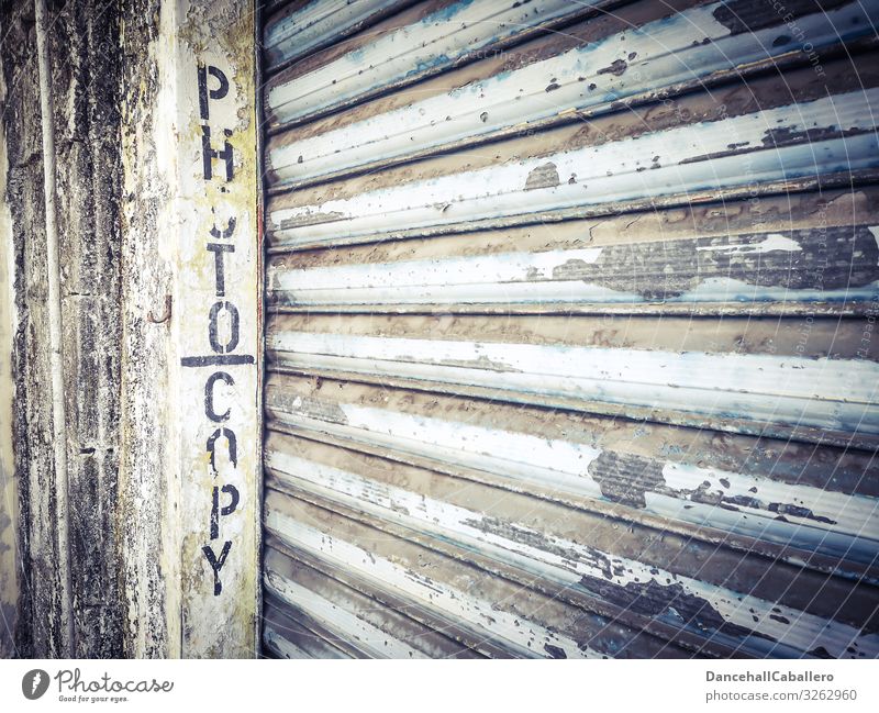 written word photocopy on a garage door Garage door Roller shutter Photocopier Town Downtown Broken Services Decline Wall (barrier) Wall (building) Facade Old