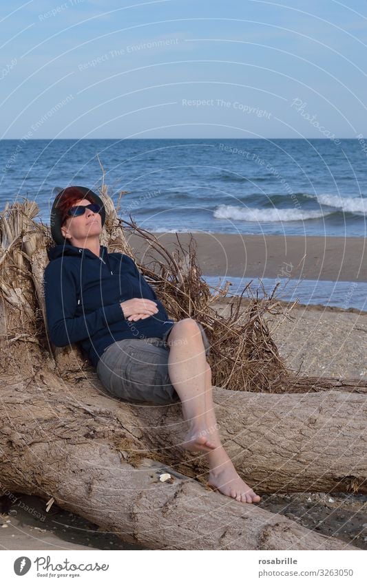 thoughts | lost | middle-aged woman sitting comfortably on the beach on flotsam and dreams Well-being Contentment Relaxation Calm Spa Leisure and hobbies