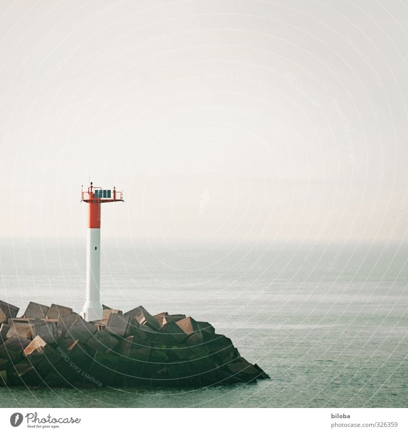 Lighthouse at the port exit into the uncertain infinity of the North Sea veiled by fog harbour exit Harbour Signal North Sea coast Ocean Fog Shroud of fog