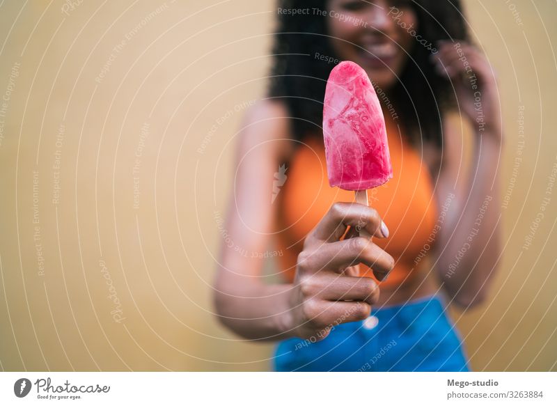 Afro woman enjoying summertime and eating an ice-cream Dessert Ice cream Lifestyle Joy Happy Beautiful Relaxation Summer Human being Woman Adults Hand To enjoy