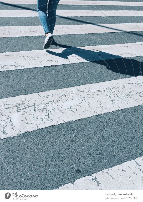 walking on the crosswalk on the street Pedestrian Legs Silhouette Shadow Line White walker traffic signal Signal Street Signage Road sign Symbols and metaphors