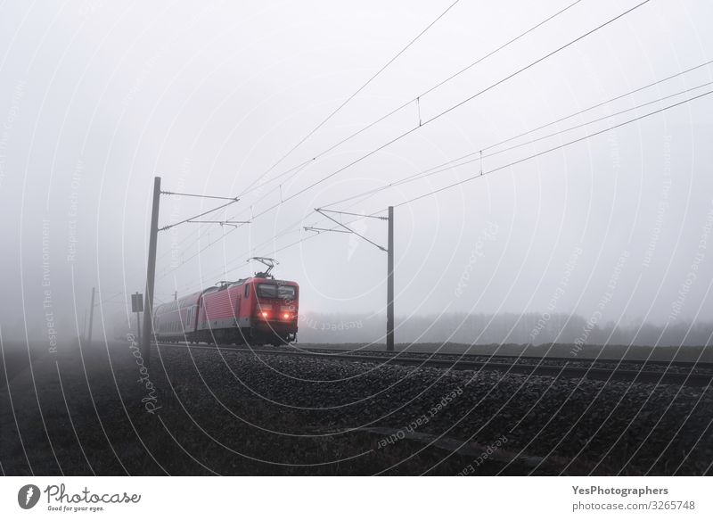 Red train locomotive through mist moving on railway tracks Vacation & Travel Trip Winter Autumn Bad weather Fog Transport Public transit Railroad Engines