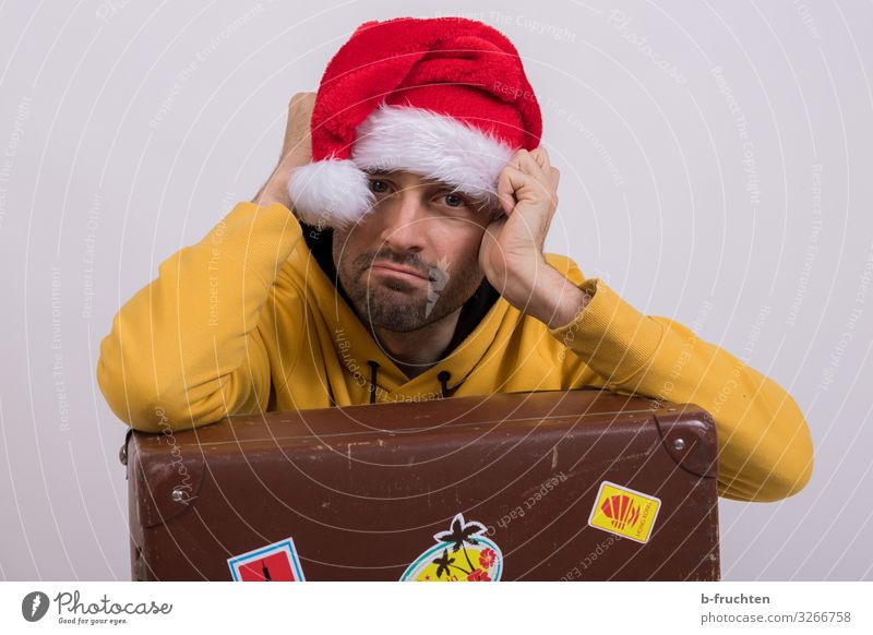 Man with Christmas cap and suitcase Economy Business Adults Face 1 Human being 30 - 45 years Sweater Cap Old Sit Dark Retro Cool (slang) Disappointment Society