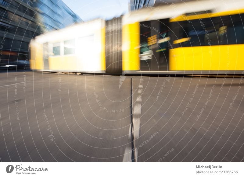 Tram in Berlin Life Means of transport Public transit Street Rail transport Driving Germany City Zoom effect Movement Transport Yellow Colour photo