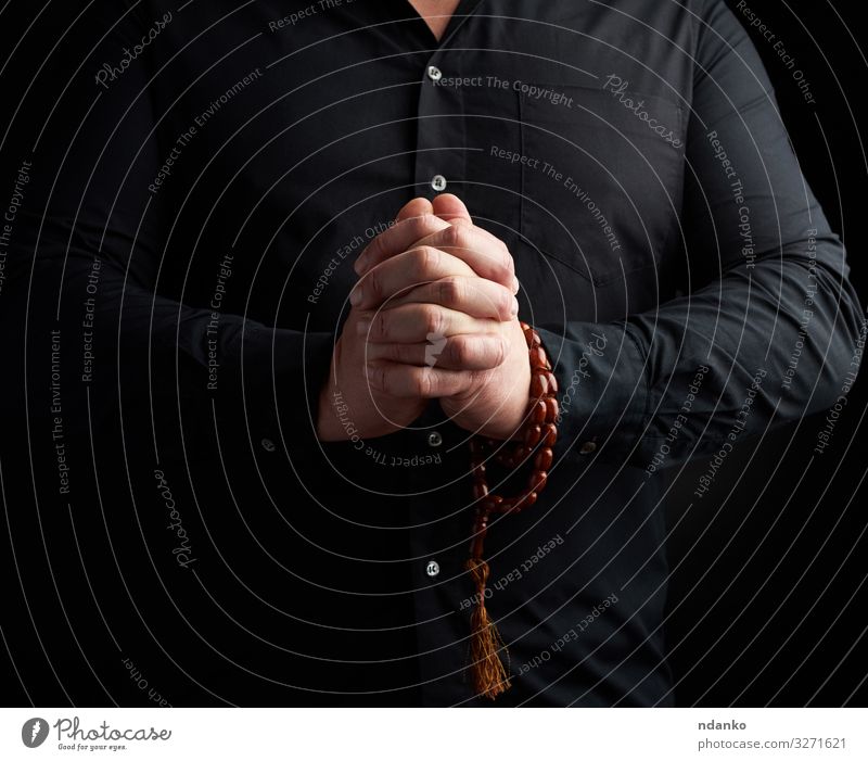 man in a black shirt joined his hands Lifestyle Harmonious Relaxation Meditation Yoga Human being Man Adults Hand Fingers Love Black Goodness Hope Peace Belief
