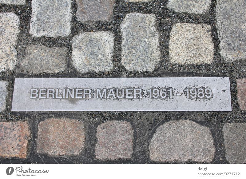 Memorial Berlin Wall on metal plate between cobblestones Capital city Paving stone The Wall Monument Stone Metal Sign Characters Historic Uniqueness Brown Gray
