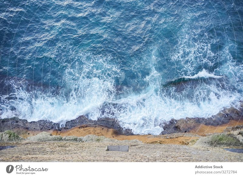 Beautiful blue sea under big mountain seascape water coast shore turquoise wave foam peak peace rock beautiful travel summer ocean nature scenery view bay