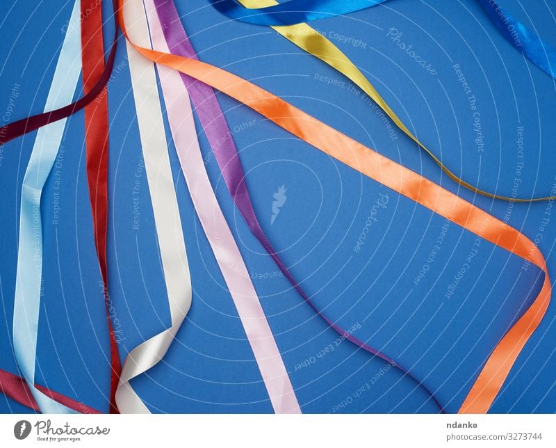 Pink silk ribbon in the shape of a loop on a blue background Stock Photo by  ndanko