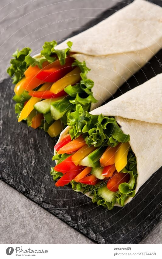 Vegetable tortilla wraps on gray stone background Wrap Roll Flat bread Food Healthy Eating Food photograph Spring Vegetarian diet Mix Carrot Lettuce Tomato