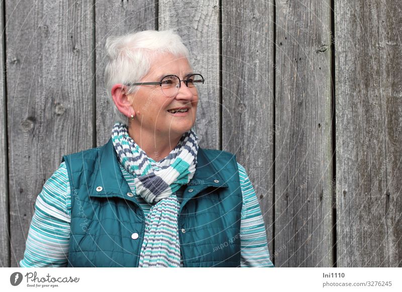 Senior looks left, smiling Feminine Woman Adults Senior citizen 1 Human being 60 years and older Hut Facade Wood Friendliness Happiness Gray Green Turquoise