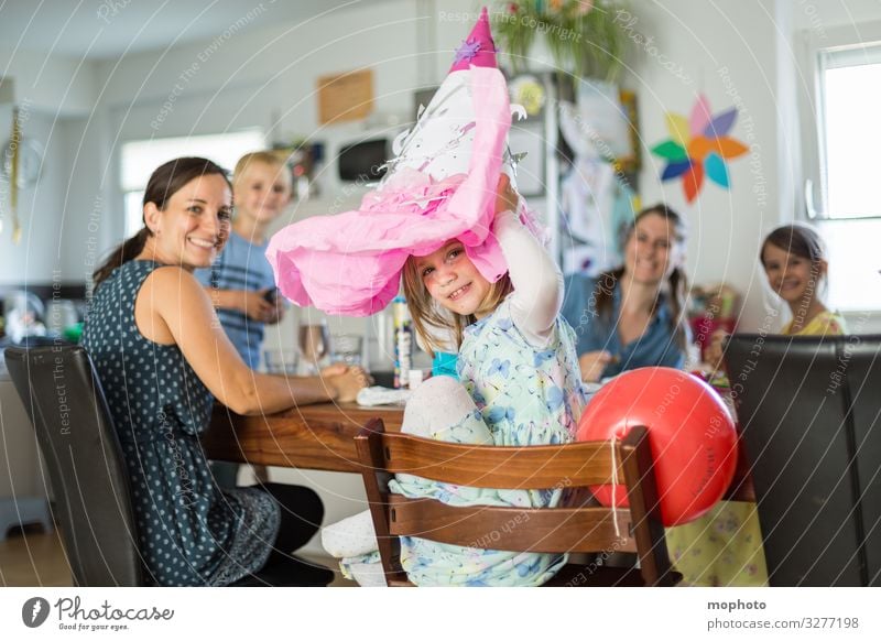 Girl with a school bag on her head, school enrolment party First day at school celebration girl School Schoolchild Parents First class first school day Family