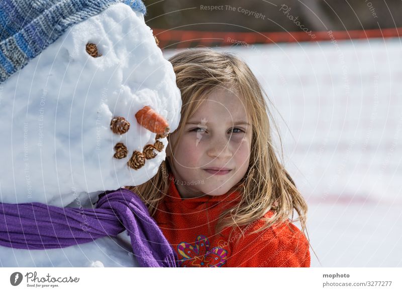 Girl with snowman girl Eyes Trip holidays Joy cheerful Happiness Face luck fortunate jeizinen chill carrot Child Head Laughter Leukerbad smile Mouth peel Snow