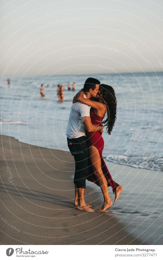 Couple kissing on beach at sunset Summer Beach Ocean Human being 2 18 - 30 years Youth (Young adults) Adults Beautiful weather Dress Long-haired Sand Kissing