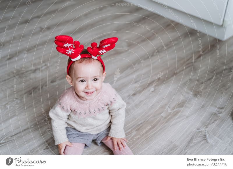 happy baby girl playing at home with reindeer diadem. Christmas concept Playing Santa Claus Mother motherhood Happy Cute Baby Girl one year Christmas & Advent