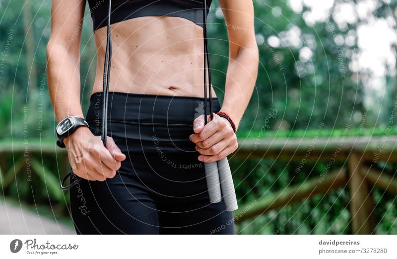 Athletic black girl exercising with skipping rope at park Stock