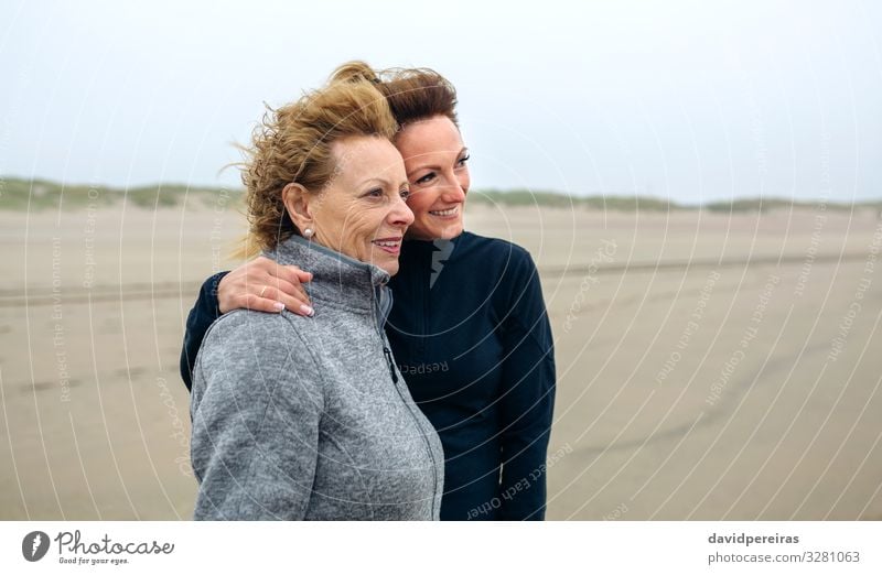 Two women looking at sea on the beach in autumn Lifestyle Joy Happy Beautiful Beach Ocean Human being Woman Adults Mother Grandmother Family & Relations Sand