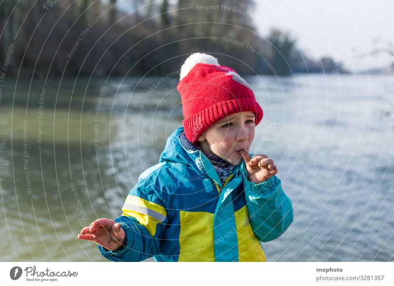 Boy with dirty fingers licks thumb Nature variegated out filth Dirty experience Fingers by hand hands Jacket Boy (child) chill Child Mouth cap natural Rhine Red