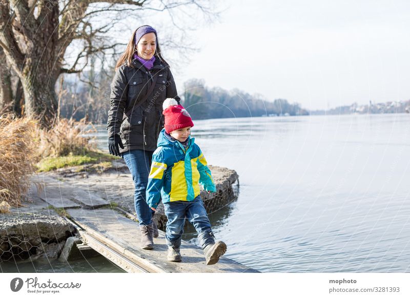 Mother walks with her little son over a wooden jetty on the water, Rhine Woman Human being Fear watch balance bridge Family River Going in common Wooden bridge