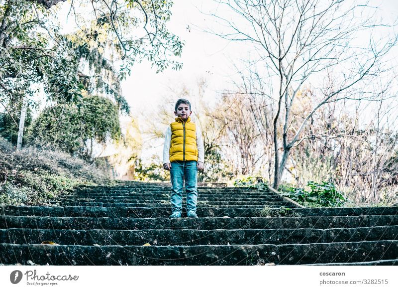 Lonely cute boy siiting on the stairs outdoors Lifestyle Style Joy Happy Beautiful Face Winter Child Human being Masculine Baby Toddler Boy (child) Infancy 1