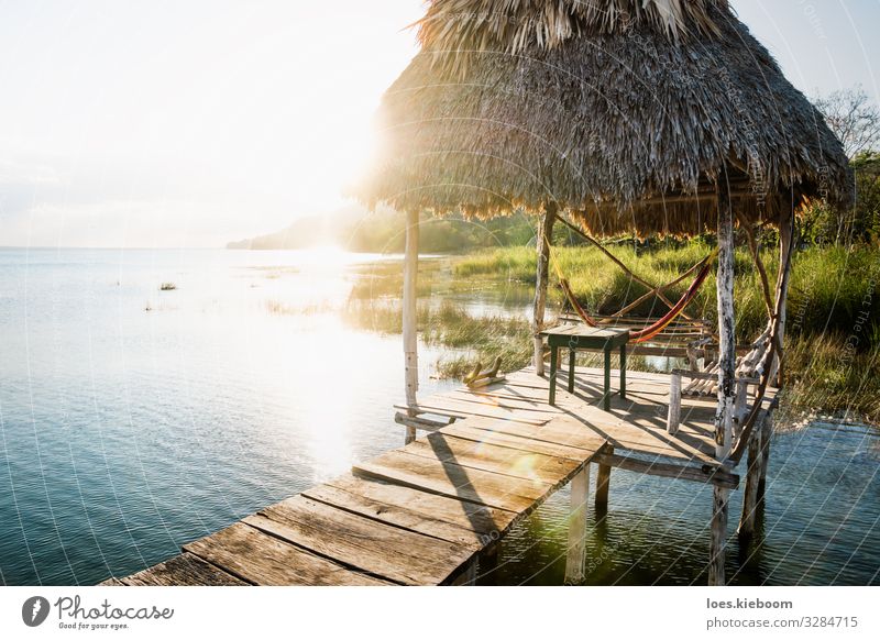 Dock during sunset with sun beam at lake Itza, Guatemala Relaxation Vacation & Travel Tourism Far-off places Summer Sun Beach Nature Landscape Foliage plant