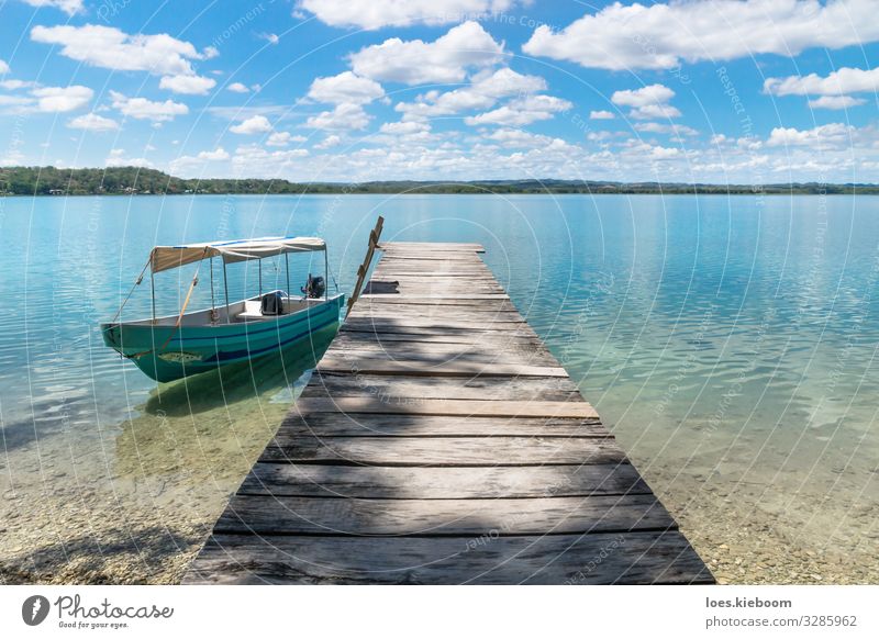 Boat at a dock at lake Itza Relaxation Vacation & Travel Far-off places Sightseeing Summer Sun Beach Nature Sky Clouds Waves Lake Boating trip Fishing boat