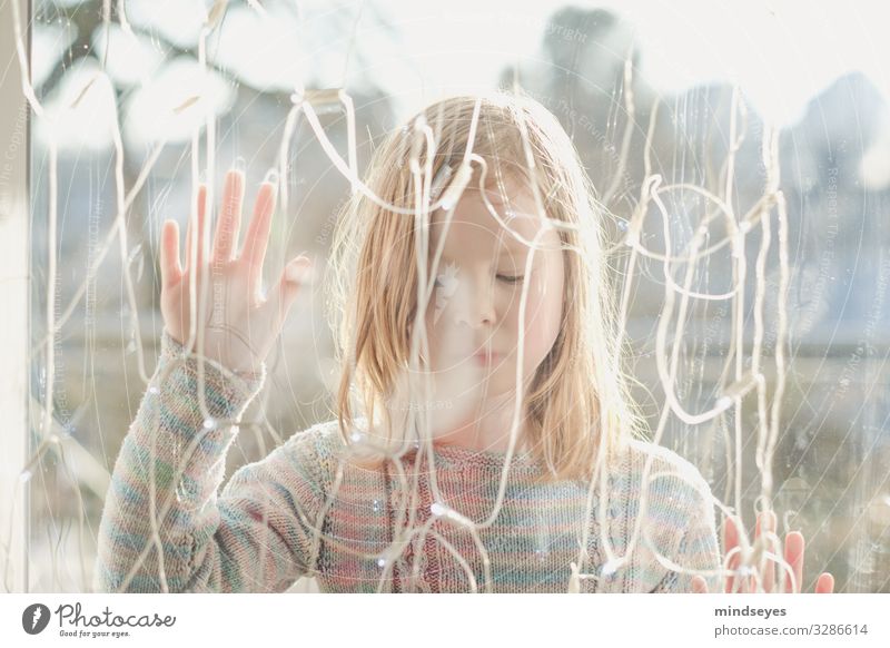 Girl standing outside behind a pane of glass with her eyes closed Living or residing House (Residential Structure) Decoration Fairy lights girl 1 Human being