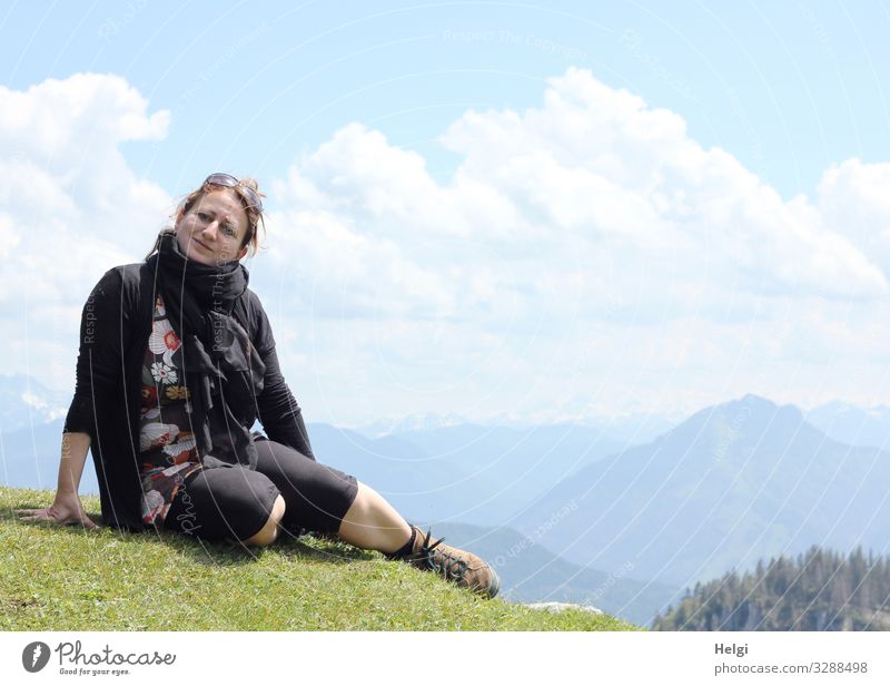 a woman is sitting on a mountain in fine weather, in the background you can see the Alps Human being Feminine Woman Adults 1 45 - 60 years Environment Nature