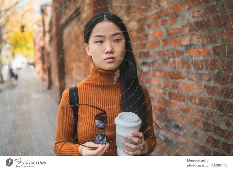 Asian woman holding a cup of coffee. Beverage Drinking Coffee Lifestyle Happy Beautiful Relaxation Human being Woman Adults To enjoy Smiling Happiness Hot