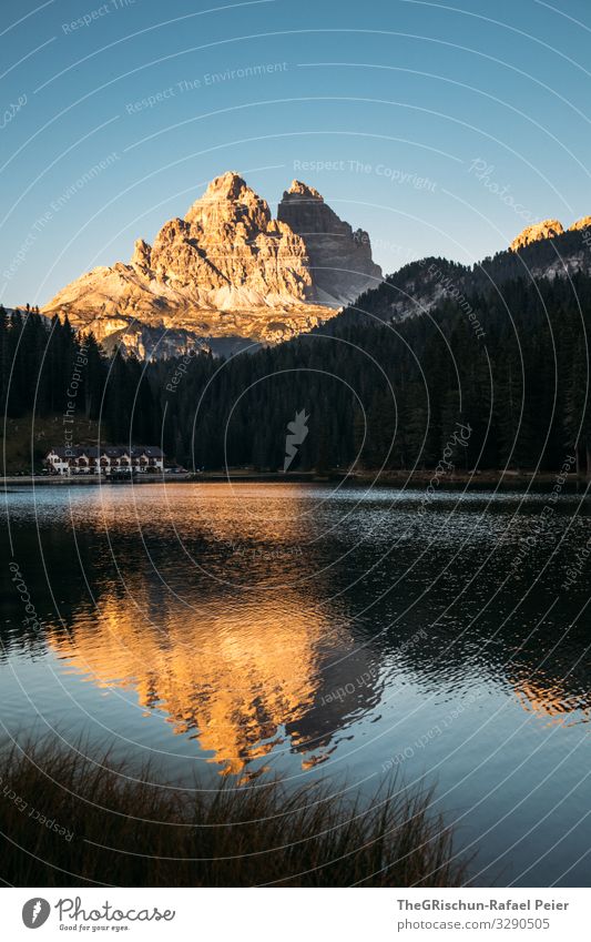 View of Tre Cime di Laveredo at the Lago di Misurina Lake mirror mountain Mountain Tre Cime di Lavaredo bank evening mood Sunset South Tyrol Sunlight Blue cute