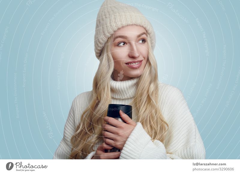 Pretty woman cradling a hot beverage in winter Beverage Face Woman Adults 1 Human being 18 - 30 years Youth (Young adults) Sweater Hat Blonde Smiling Hot pretty