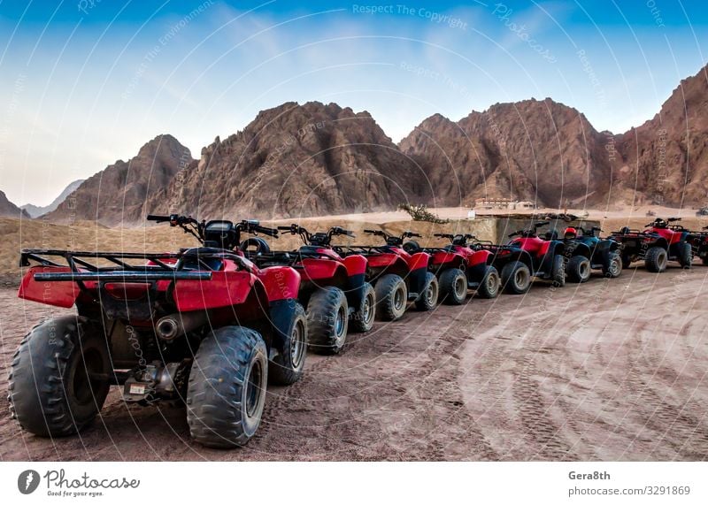 series of ATVs on the background of mountains in the desert Summer Mountain Machinery Sand Sky Rock Transport Street Stone Blue Red Egypt Sharm El Sheikh