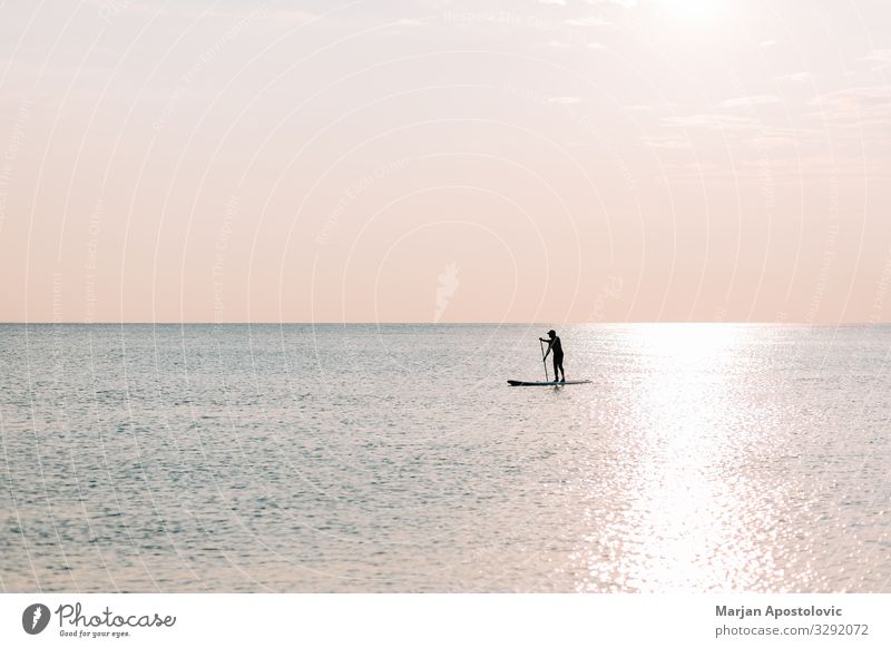 Man riding a board on the sea in sunset Lifestyle Joy Athletic Fitness Harmonious Leisure and hobbies Vacation & Travel Tourism Adventure Freedom Summer
