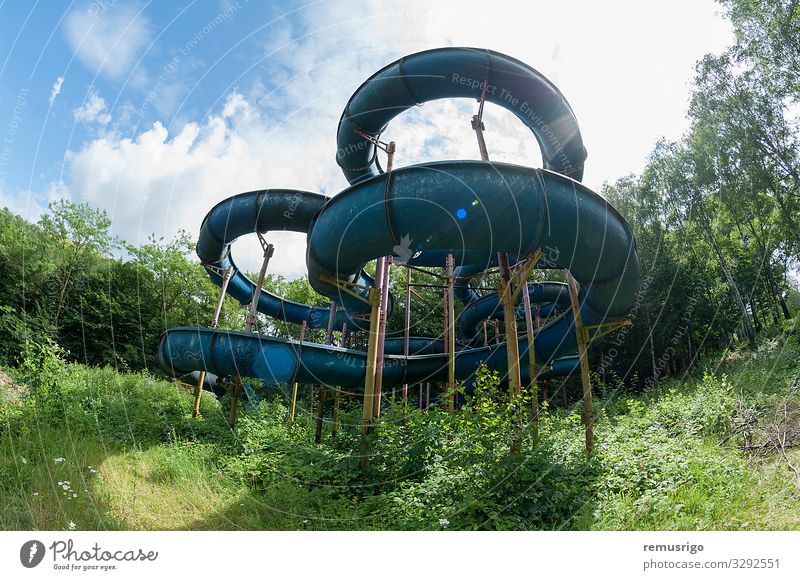 Abandoned water slide Relaxation Summer Sports Sky Clouds Tree Rust Looking Old Joy abandoned amusement slider sunflare Water slide Colour photo Exterior shot
