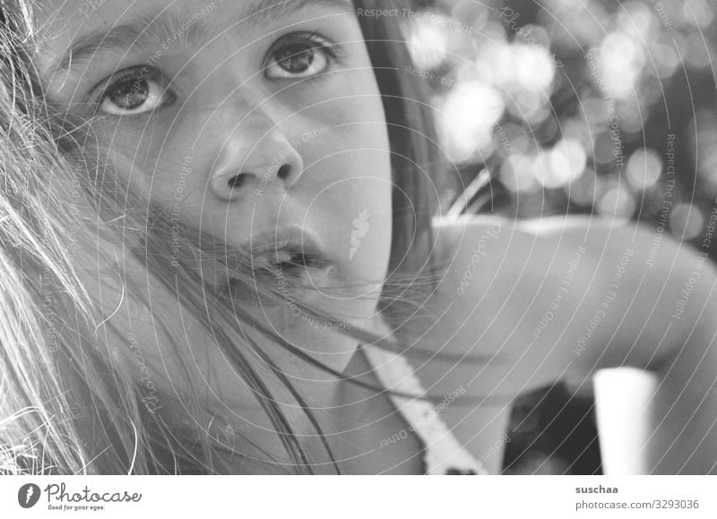 childhood Child Girl Portrait photograph Face Black & white photo Hair and hairstyles Summer Exterior shot Arm Eyes Nose Mouth Looking Blur Sunlight Upward