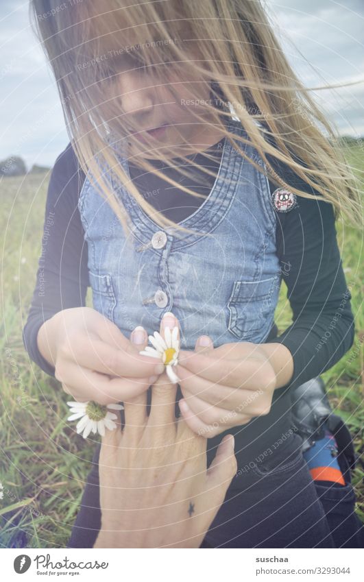 ring of daisies .. Child Girl Infancy Hair and hairstyles Wind Exterior shot Flower Flower meadow Daisy Marguerite Chamomile Meadow flower Hand Fingers Ring