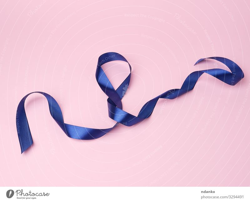 blue silk thin ribbon twisted on a pink background - a Royalty