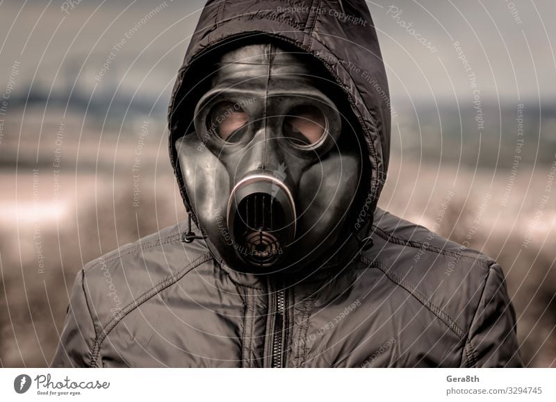 portrait of a man in a gas mask and a hood Factory Industry Human being Man Adults Environment Nature Landscape Plant Sky Clouds Tree Clothing Threat Dirty Dark