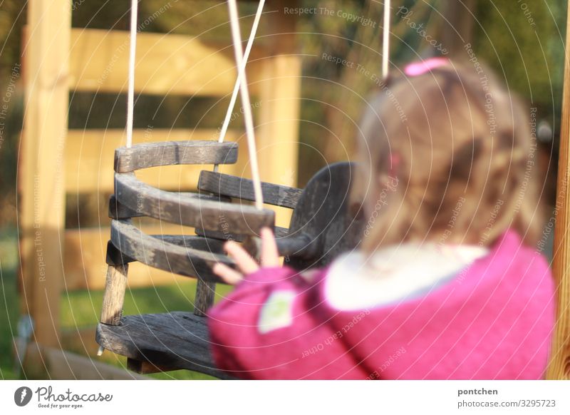 Toddler stands in front of empty swing and pushes it. Child's play Human being Feminine 1 1 - 3 years To swing Swing wood push-start Jostle by hand wollwalk