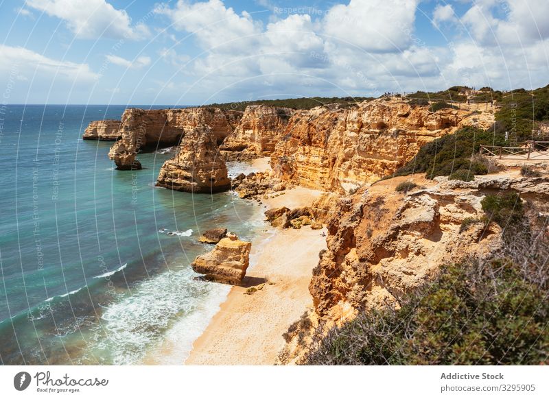 Cliffs and blue sea in countryside cliff wave nature weather tide rock rough clean portugal water ocean coast shore nobody formation stone mountain landscape