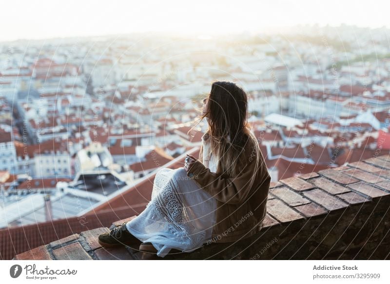 Dreamy woman sitting on border near city town morning rest sunny young dreamy admire portugal female cityscape weekend barrier brick relax lifestyle dawn