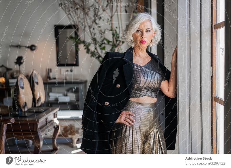 Bossy elegant woman against vintage interior in country house luxury retro stylish fashion aged appearance jacket classy well dressed charismatic bossy senior