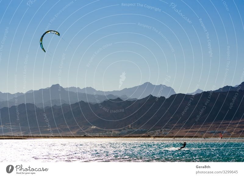 kitesurfer rides in the Red Sea in Egypt Dahab Exotic Vacation & Travel Tourism Summer Ocean Waves Mountain Sports Aquatics Nature Landscape Sky Horizon Wind
