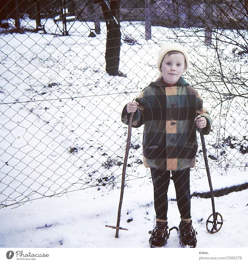 ready for departure Winter sports Skiing Skis Feminine Girl 1 Human being Snow Tree Jacket Coat Cap Fence Observe Looking Stand Determination Passion