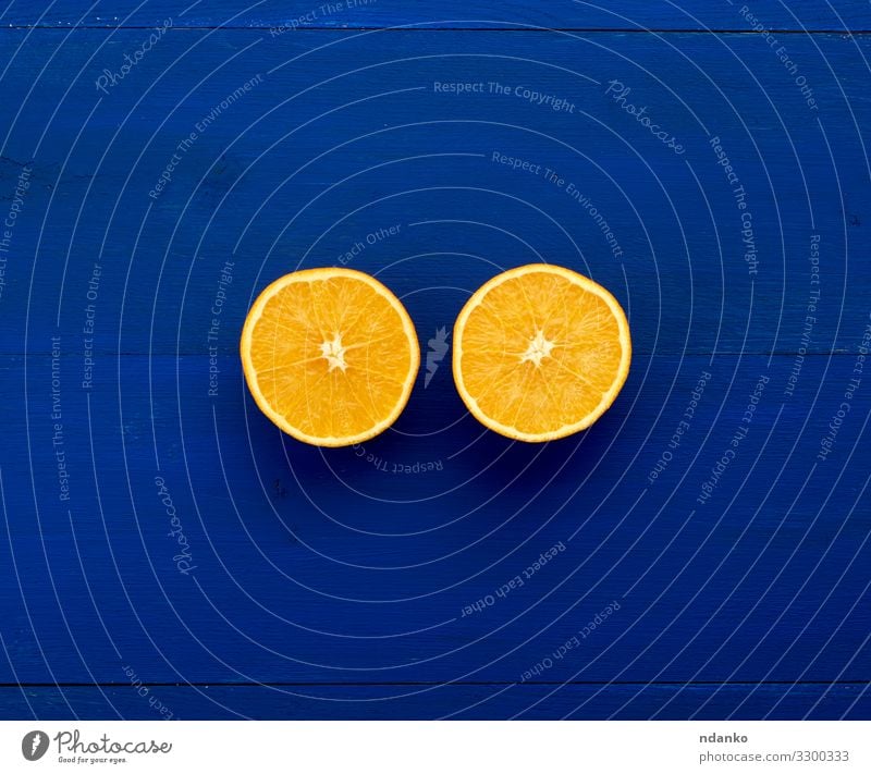 two halves of an orange round orange Fruit Dessert Nutrition Vegetarian diet Diet Juice Nature Wood Fresh Small Natural Juicy Blue Colour Half background citrus