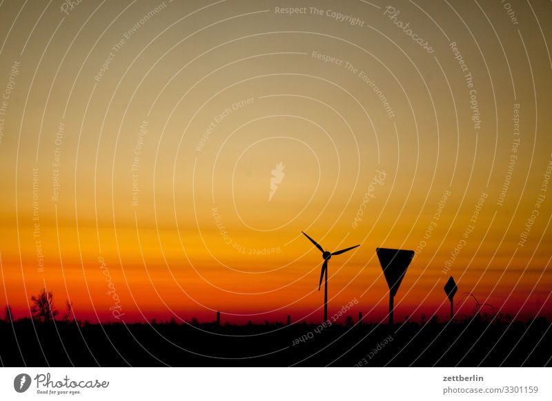 Wind turbine and traffic signs Village Twilight Far-off places Horizon Landscape Mecklenburg-Western Pomerania Deserted Baltic Sea Rügen Sun Sunset Copy Space