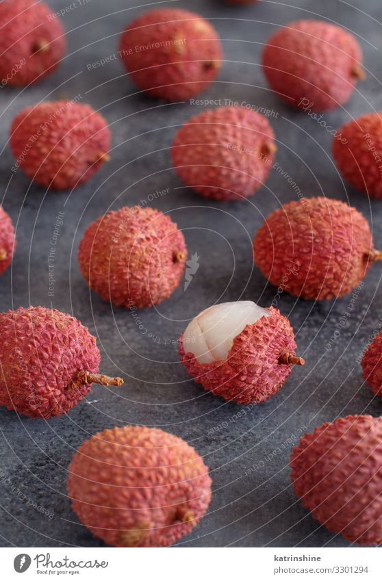Fresh litchi fruits on a grey table Fruit Diet Exotic Juicy Gray Pink Lychee litchi fruits fruit Raw Open chinese asian Tropical Fruit flesh sweet lichi Lechee