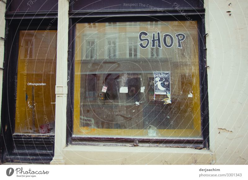 Shop with ghost. An abandoned shop - SHOP - with a small poster showing a ghost. Shopping Calm Decoration Trade Summer Beautiful weather Town Germany Building